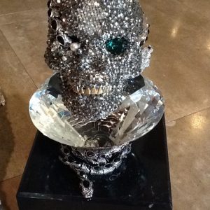 CRYSTAL AND EMERALD SKULL WITH MARBLE BASE